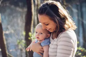 Mom Smiling While Holding Baby (1)